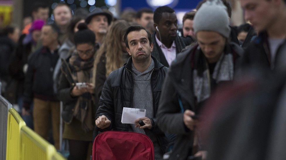 Commuters wait for a delayed service during an earlier strike