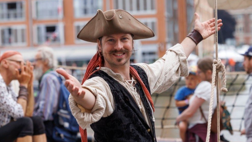 Gloucester Tall Ships Festival character in pirate costume smiling at the camera