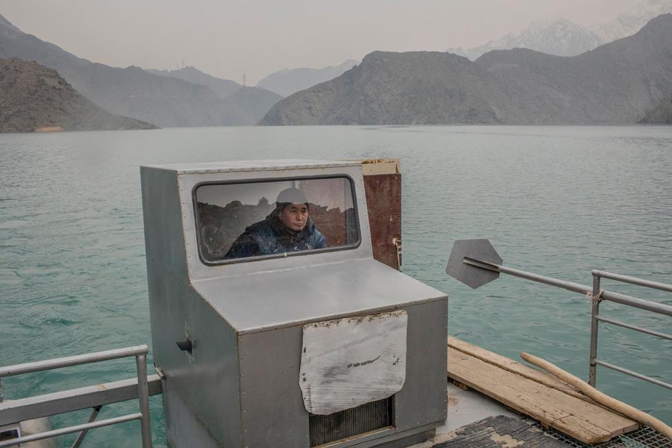 Sonunbek Kadyrov pilots his water taxi, serving the village of Kyzyl-Beyit, Kyrgyzstan, on 16 March 2021.