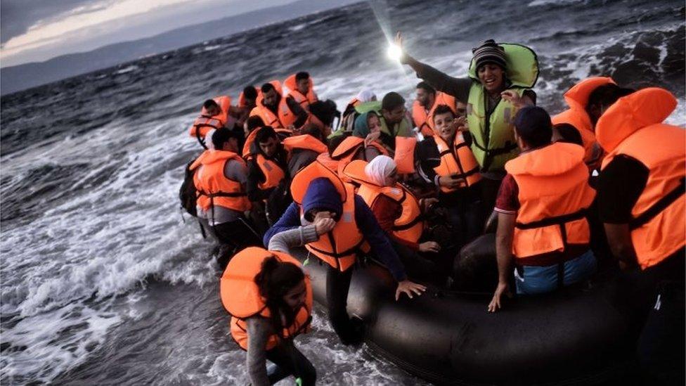 Refugees and migrants arrive at the Greek island of Lesbos after crossing the Aegean sea from Turkey on 1 October 2015.