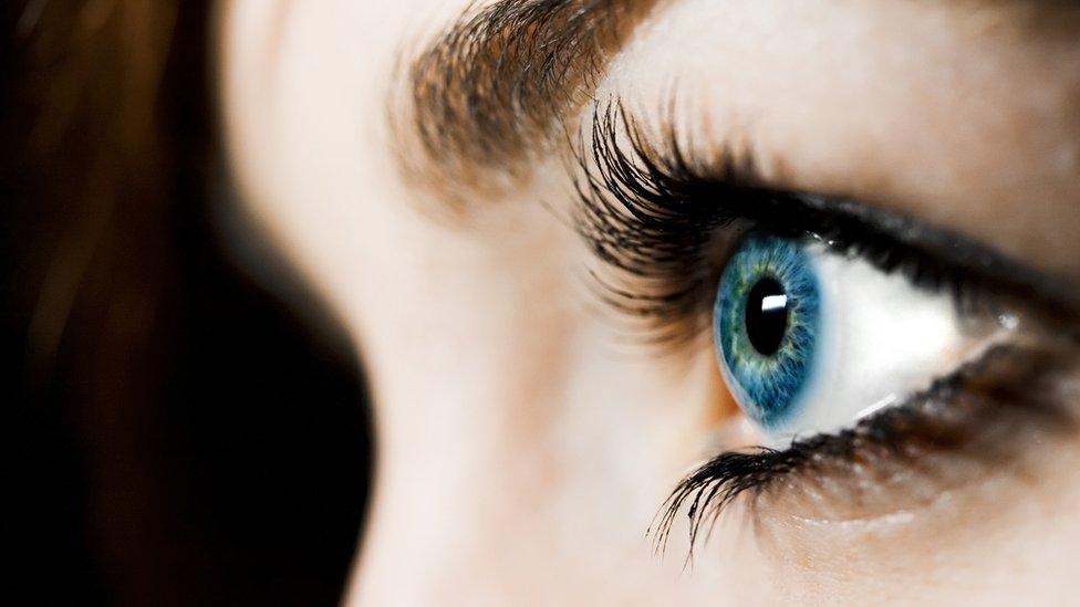 Close up of a woman's eye wearing a blue coloured lens