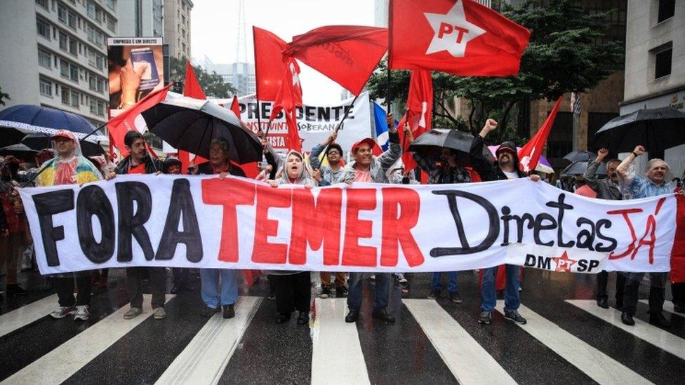 "Temer out, elections now," reads the banner held during a protest in Sao Paulo. 21 May 2017