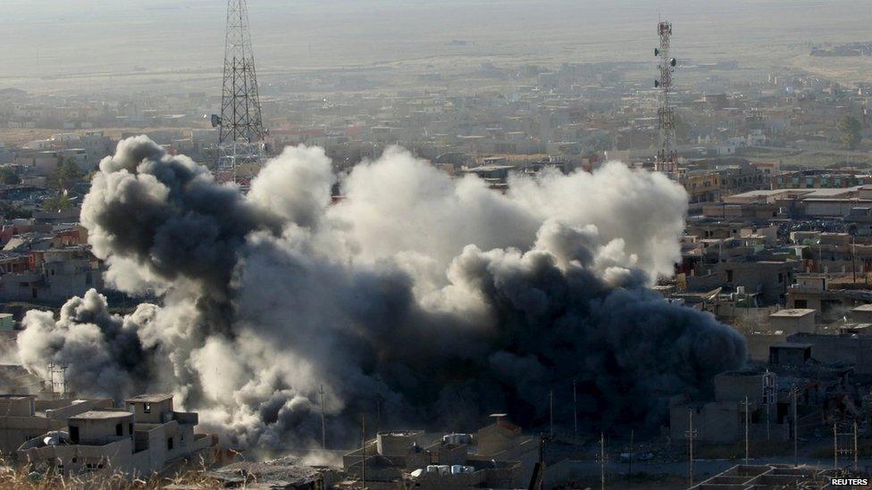 Smoke rises from the site of U.S.-led air strikes in the town of Sinjar