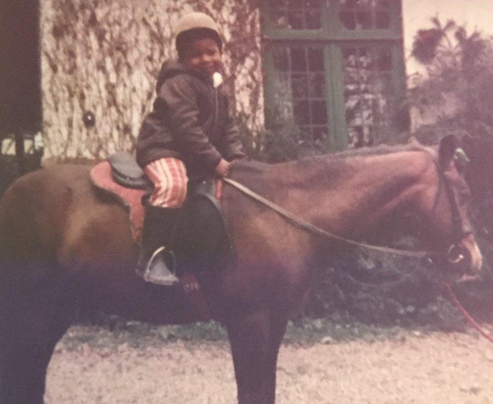 Dionne Draper as a child on a horse.