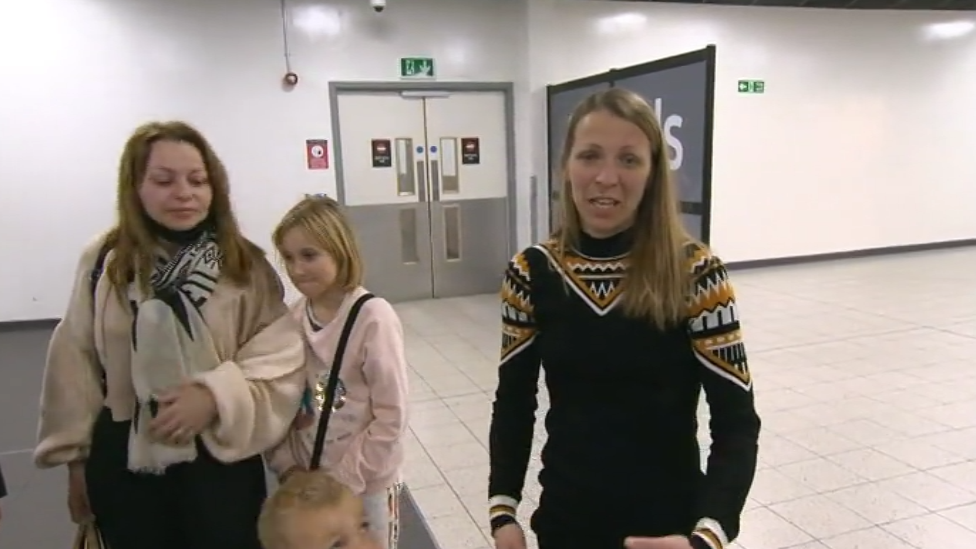 Two women and a girl at an airport