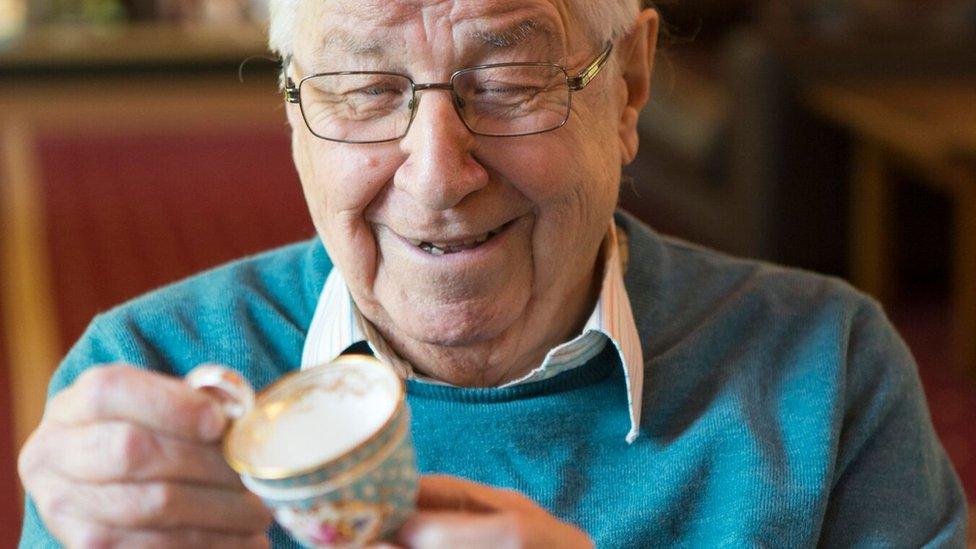 Henry Sandon with a piece of Nantgarw porcelain