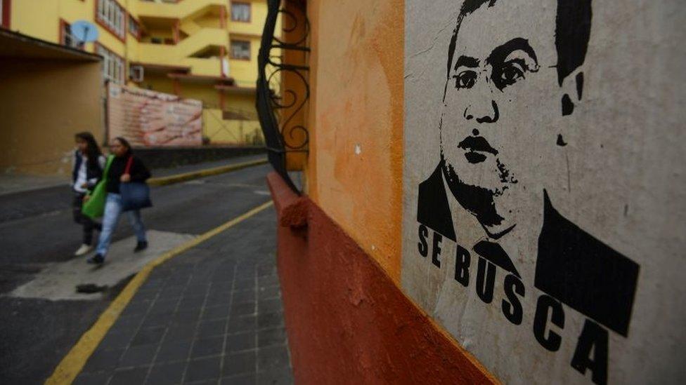 Women walk by a poster depicting outgoing Veracruz Governor Javier Duarte with the word "Wanted" at a neighbourhood in Xalapa, Mexico, October 25, 2016.