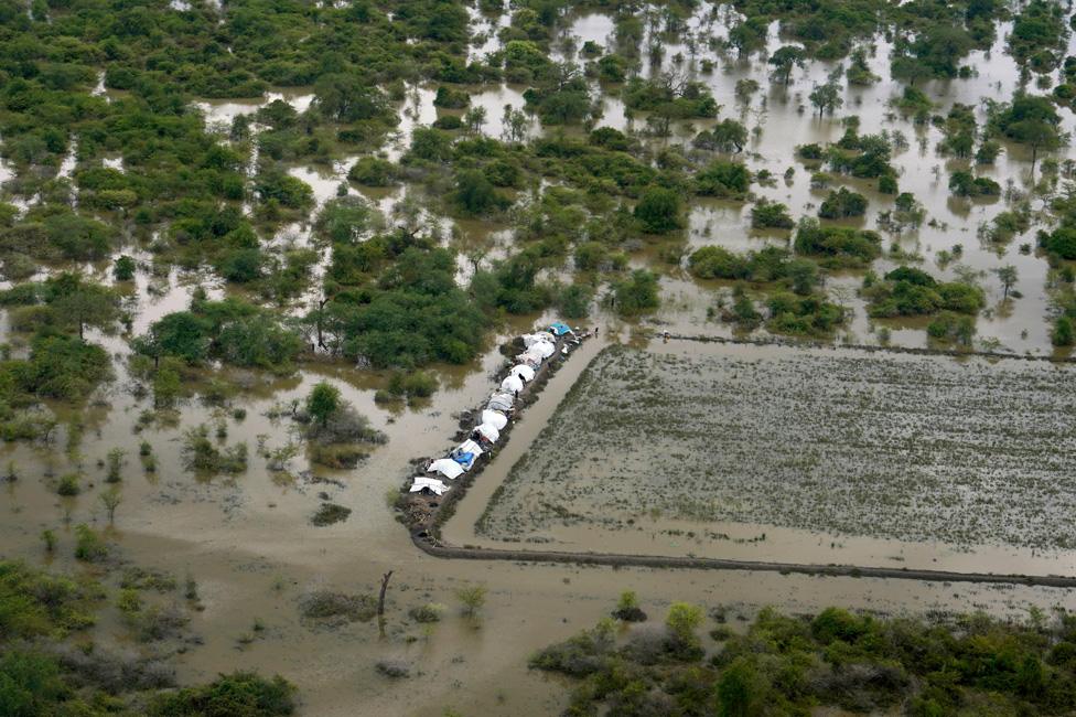 Tents surrounded by water are seen from an aerial view, after heavy rains and floods forced hundreds of thousands of people to leave their homes