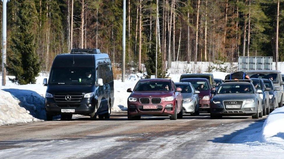 Cars pictured queueing up to cross the border into Finland from Russia