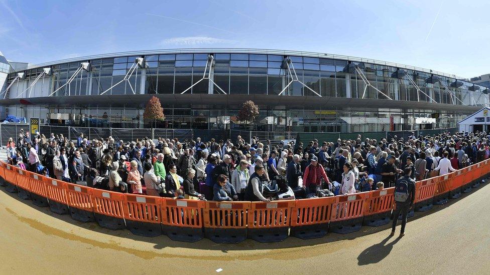 People queue outside the departure hall at Brussels airport