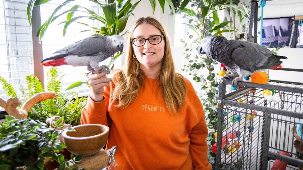 Lesley Herbert with her parrots