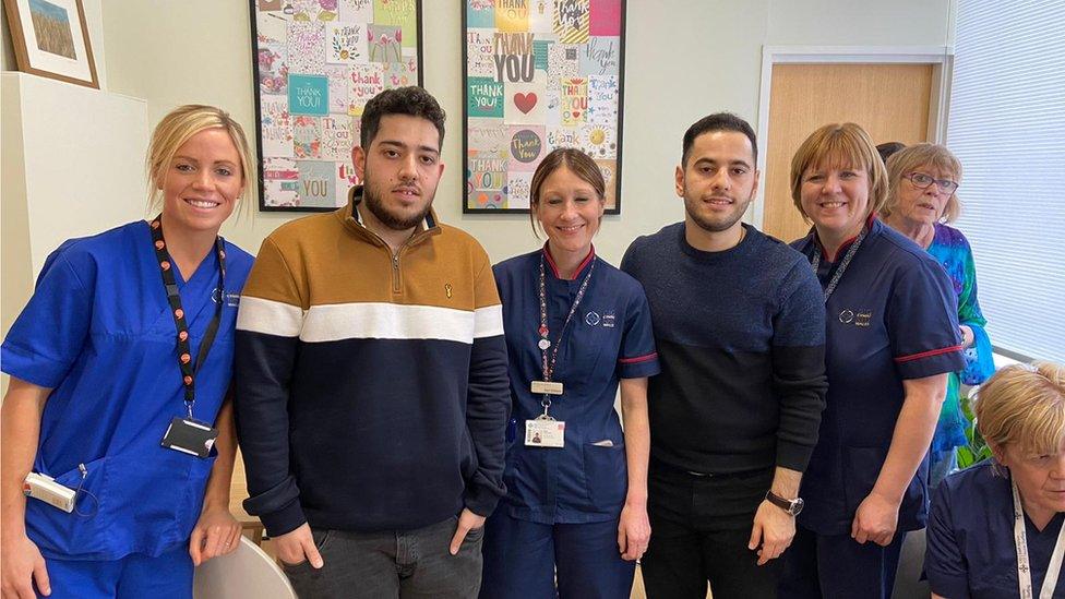 The Amiri brothers with some of the NHS staff who helped them