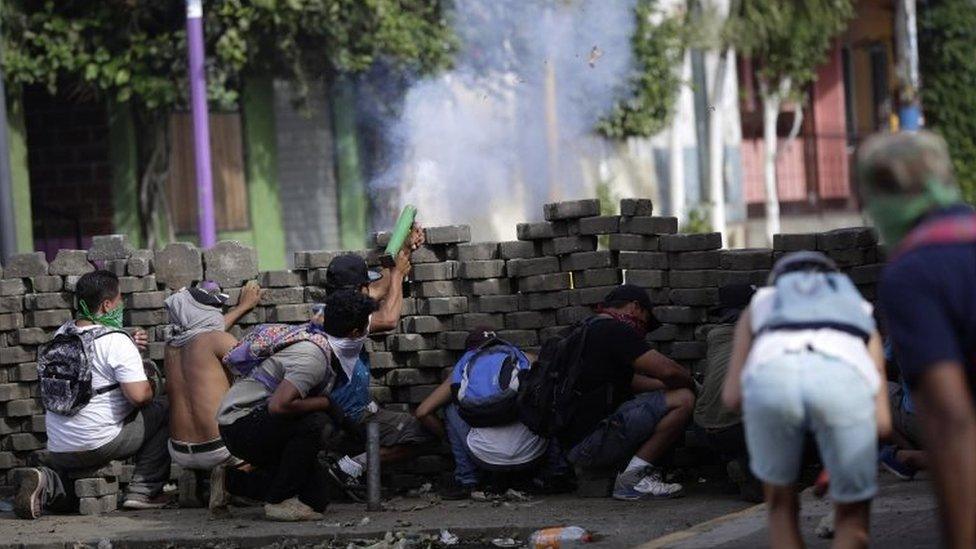 Protesters take cover behind a makeshift barrier during ongoing protests in Masaya, Nicaragua, 09 June 2018. Nicaragua saw renewed protests after President Daniel Ortega failed to respond to a letter calling for "democratization" of the country.