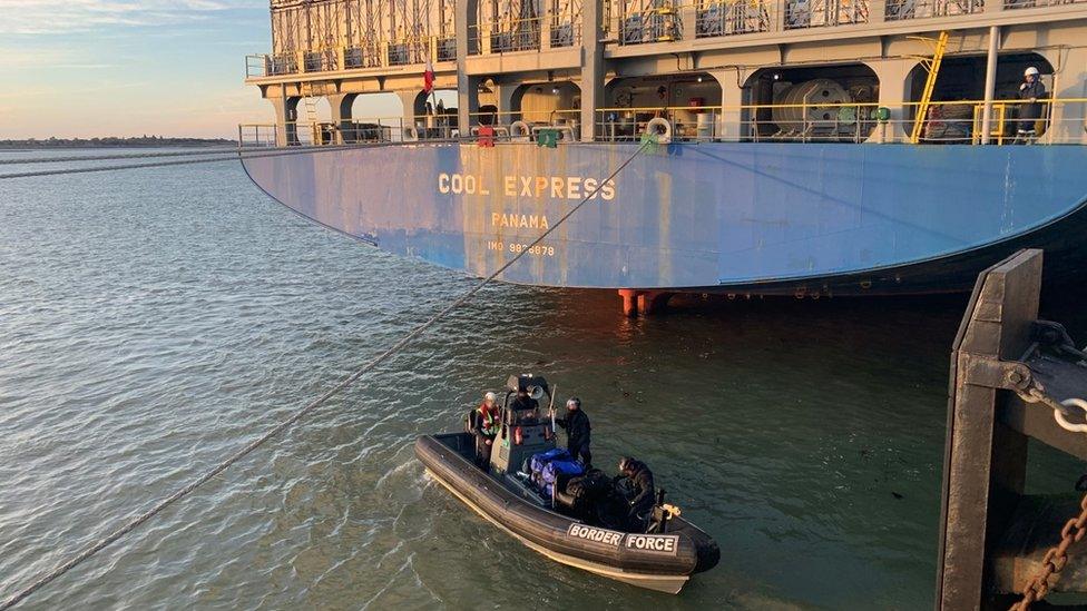 The ship with a Border Force boat below it