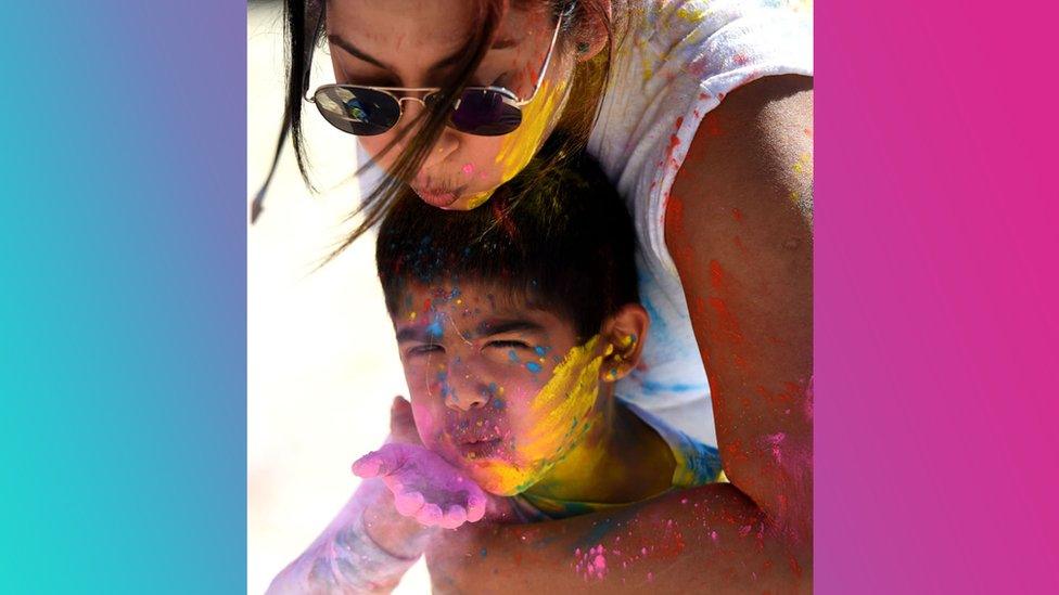 Kavitaand her son Rishab blow colours during a Holi celebration in California