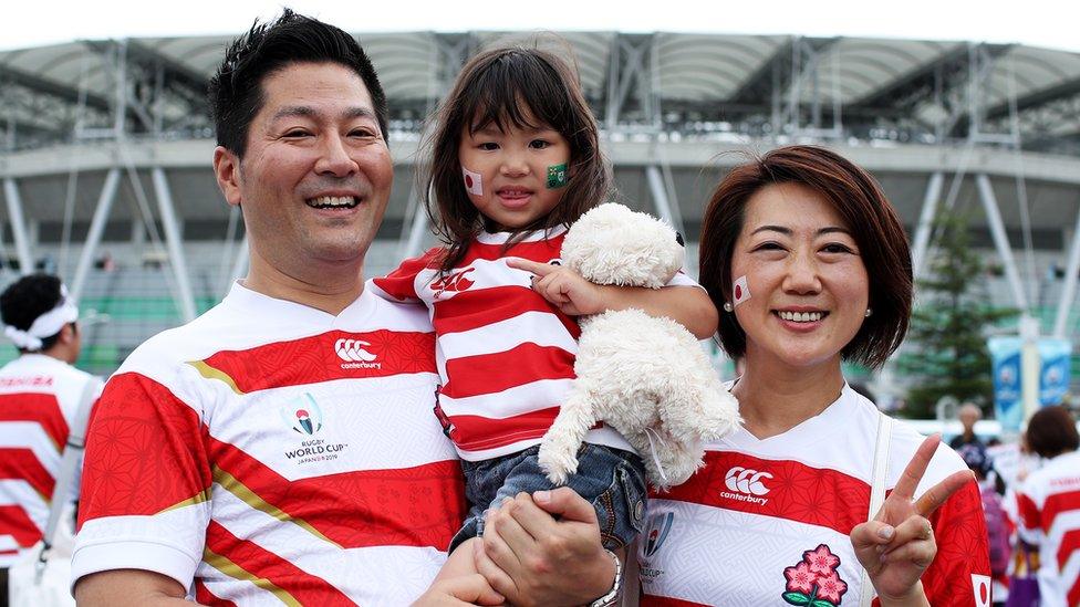 Japanese fans pose outside the Shizuoka Stadium Ecopa in Shizuoka, Japan.