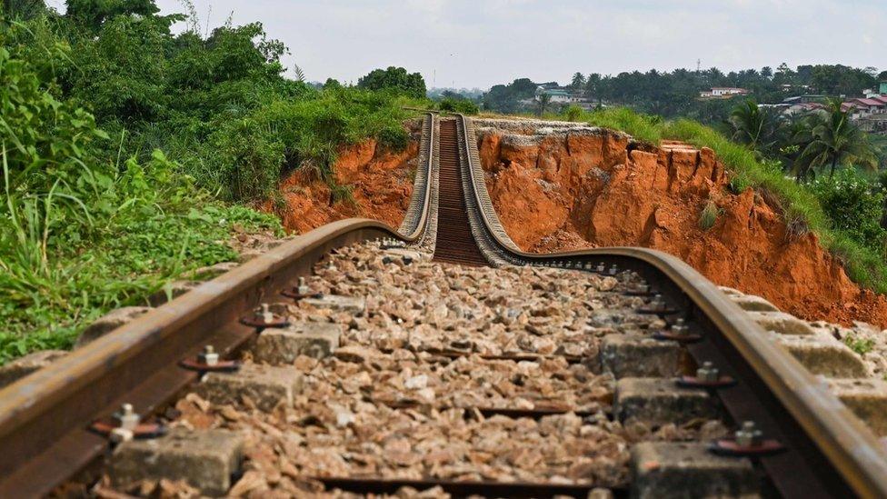 A suspended railway track at the site of a landslide that killed 13 people the day before, in Anyama, near Abidjan -19 June 2020