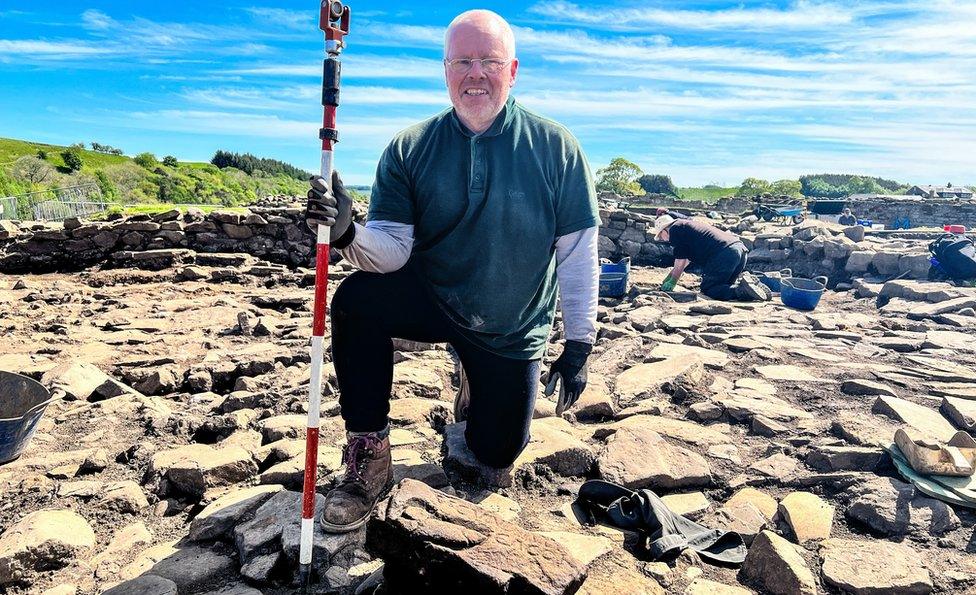 Dylan Herbert with the stone at Vindolanda