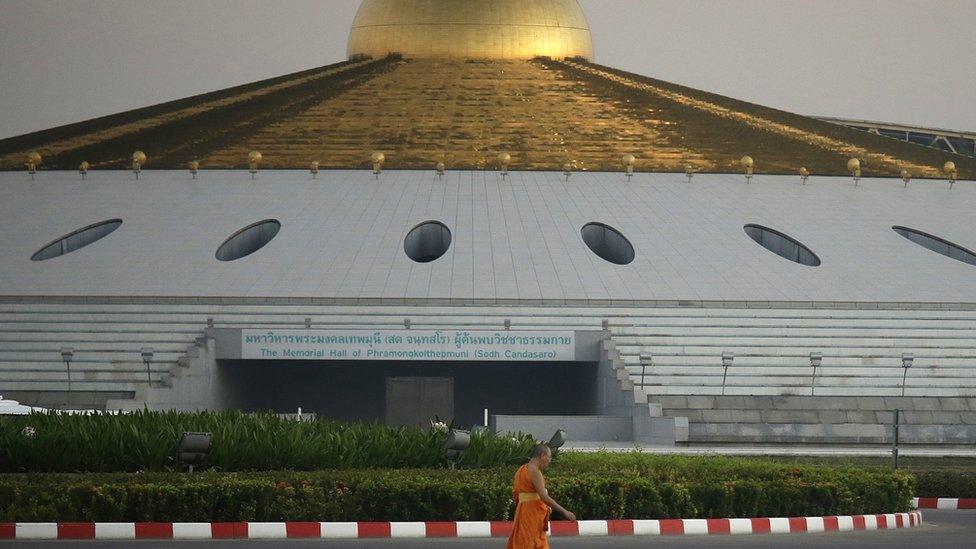 A Buddhist monk walks inside Wat Dhammakaya temple in Pathum Thani province, Thailand, Thursday, 16 February 2017