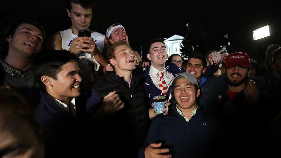 A group of Trump supporters sing in front of the White House after midnight on November 9, 2016 in Washington, DC.