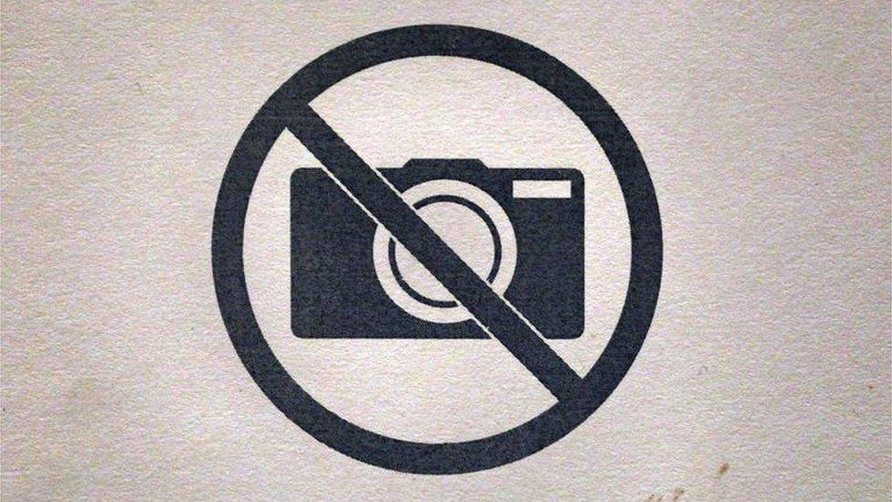 A no photography sign