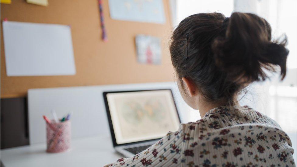 Child sitting at computer