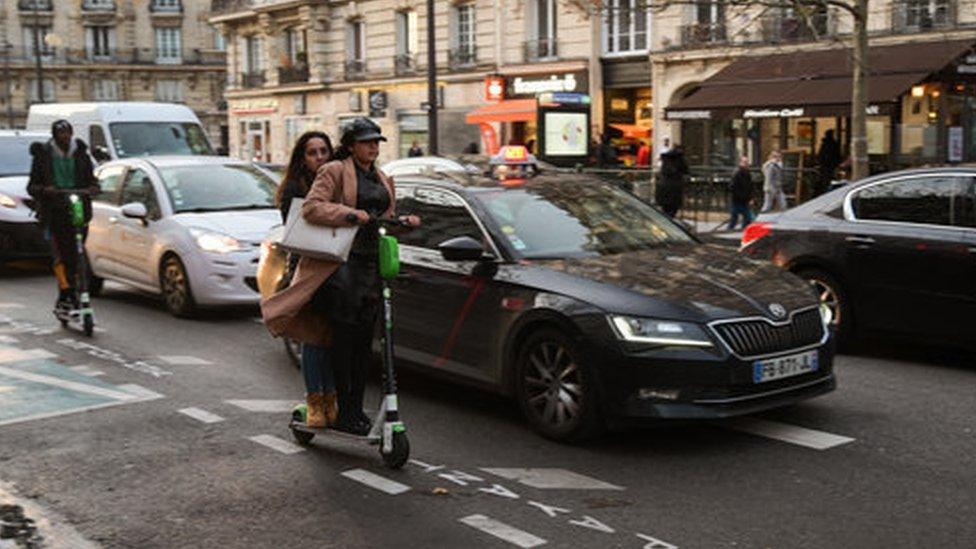 People ride their electric scooter in Paris, France, on December 16, 2019