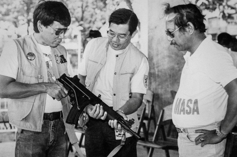 Mayor Rodrigo Duterte poses with his Uzi submachinegun in the mountainous village of Carmen in the Baguio District of Davao city in the southern Philippines