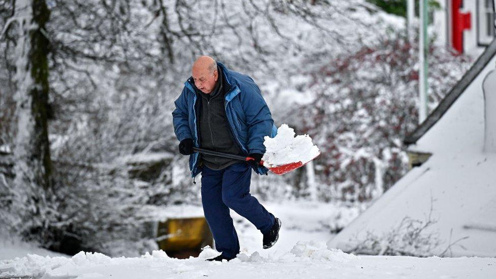 A man shovels snow in Scotland