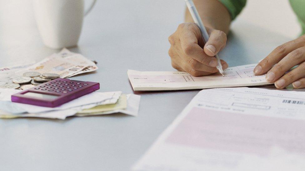 A person writing a cheque