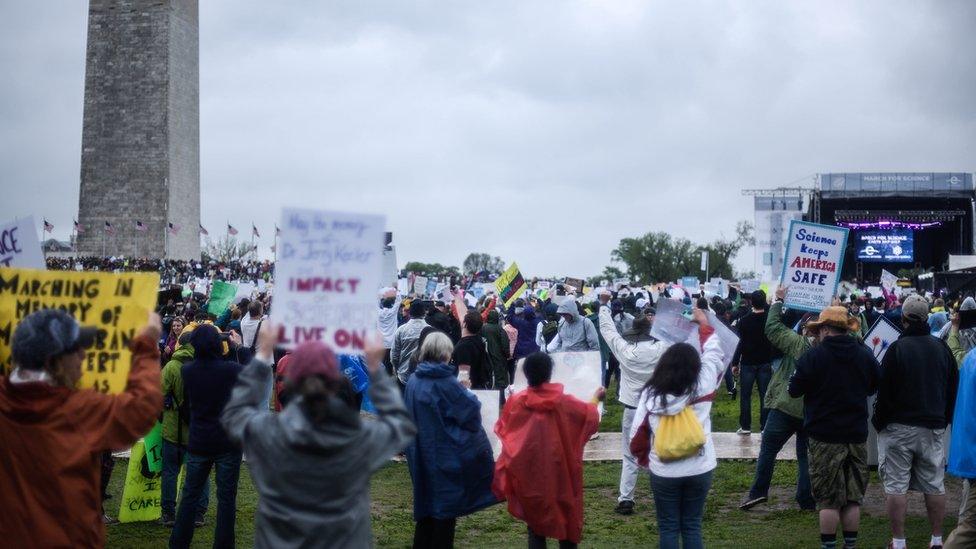 Protesters gather in their hundreds by Washington Monument, next to a stage