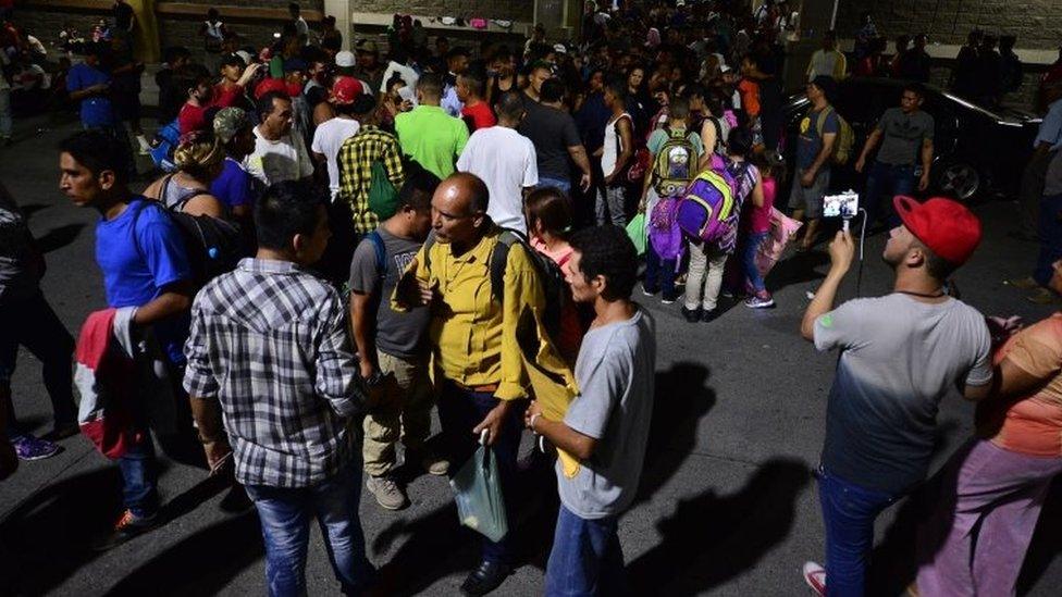 Honduran families line up to board a bus leaving the Metropolitan Center of San Pedro Sula, 300 kms north of Tegucigalpa, travelling towards the Guatemala border on April 9, 2019.