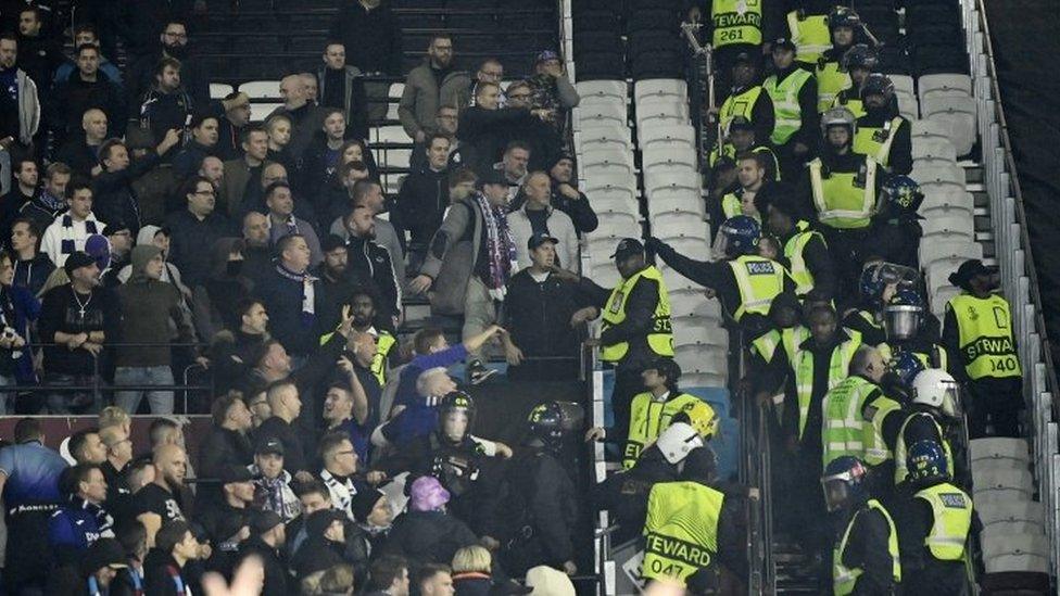 Riot Police move in on seats in the away area of London Stadium during the West Ham v Anderlecht match