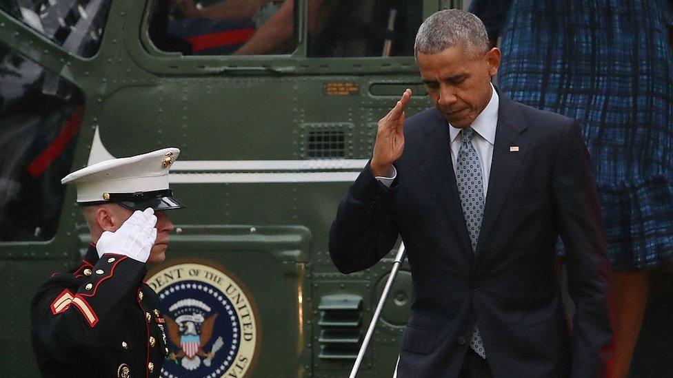 President Barack Obama salutes a US Marine as he steps off Marine One