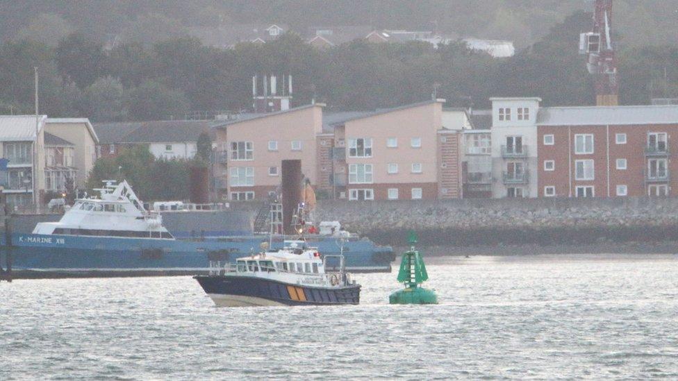 Southampton Harbour Master launch inspecting a buoy off Hythe, Hampshire