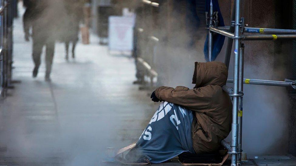 Homeless man sits outside in Canada