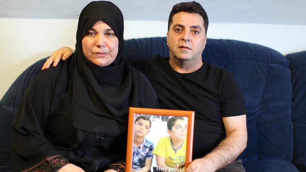 Rafat and Ferial Hazeema with a photo of their two sons