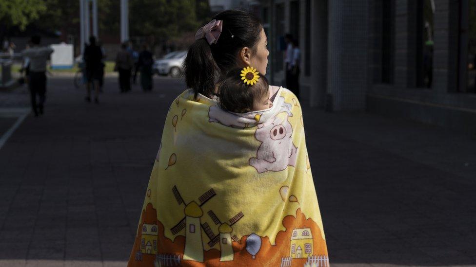 Mother and child walk around in Pyongyang