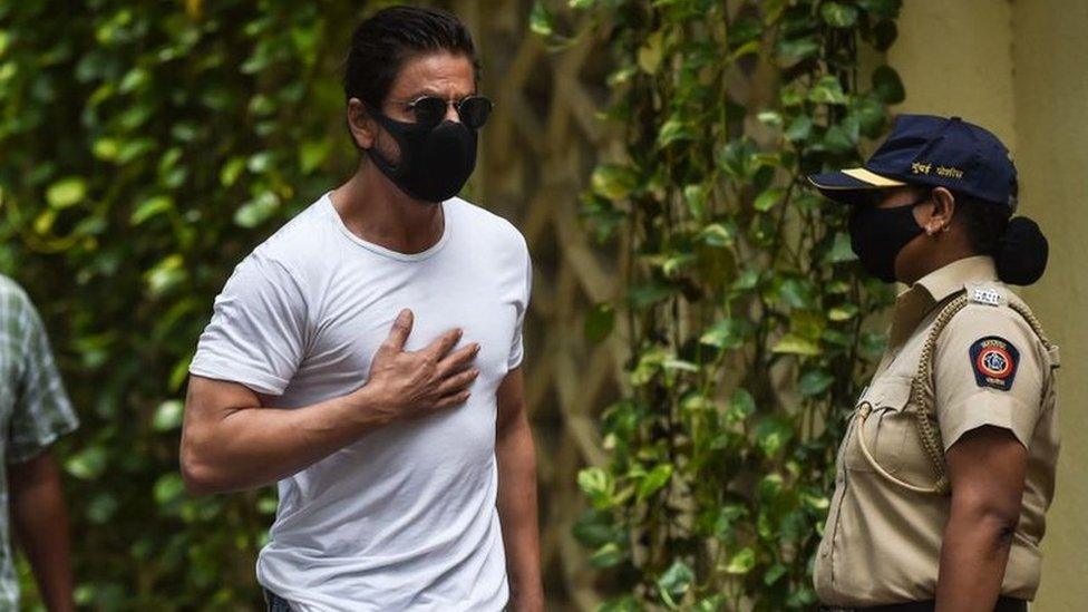 Bollywood actor Shah Rukh Khan (C) arrives to pay his respect at the residence of late Bollywood actor Dilip Kumar, after he died at the age of 98 in Mumbai on July 7, 2021.