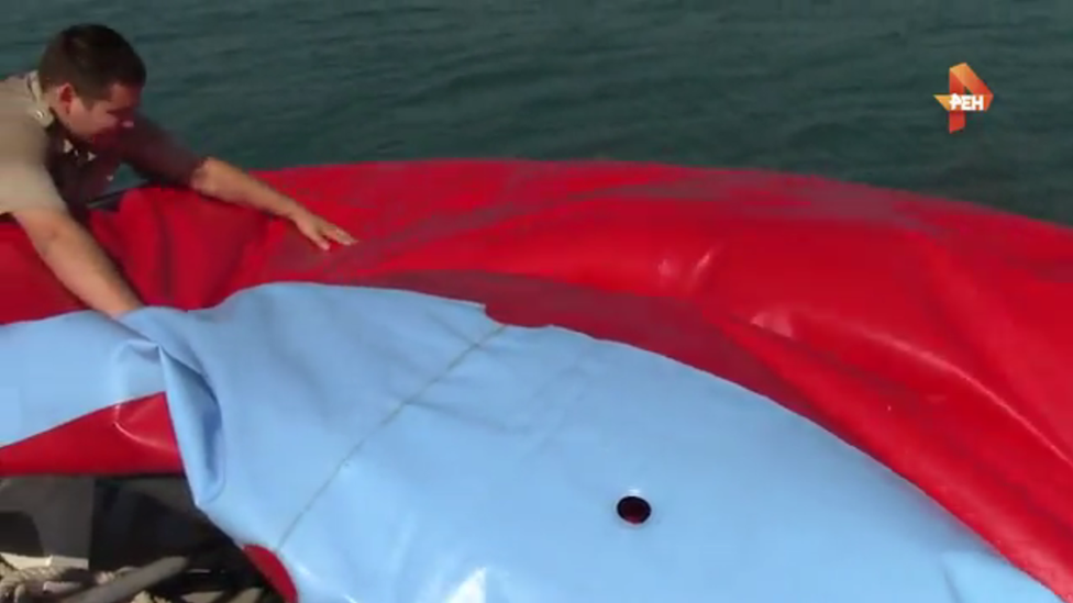 Coastguards deflate a water trampoline