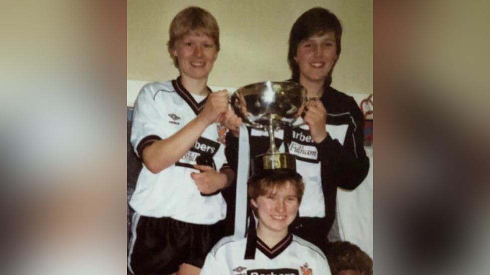 Lori Hoey (left) clutches the cup after their 1985 triumph