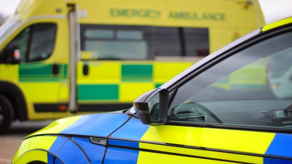 Stock image of a police car and ambulance