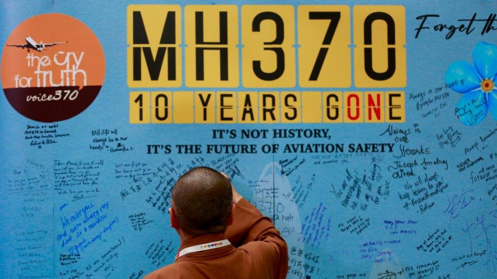 A man writing messages at the Day of Remembrance for MH370 in Petaling Jaya, Malaysia, on 3 March, 2024.