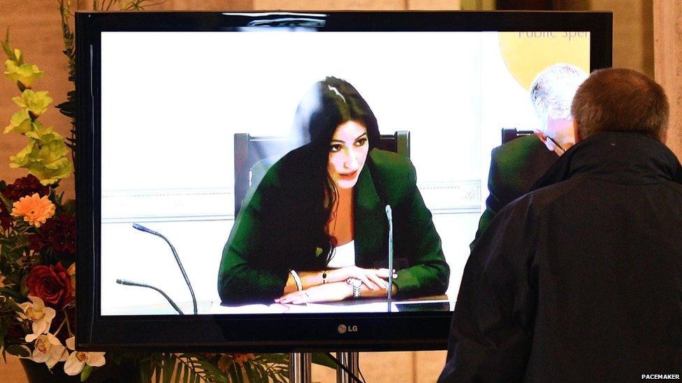 Man watches finance committee - chaired by Emma Little-Pengelly - on TV screen at Stormont, 23 August 2016