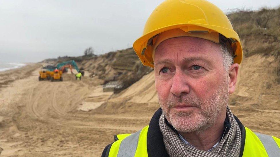 Steve Reed pictured on Hemsby Beach with heavy plant machinery in the background.