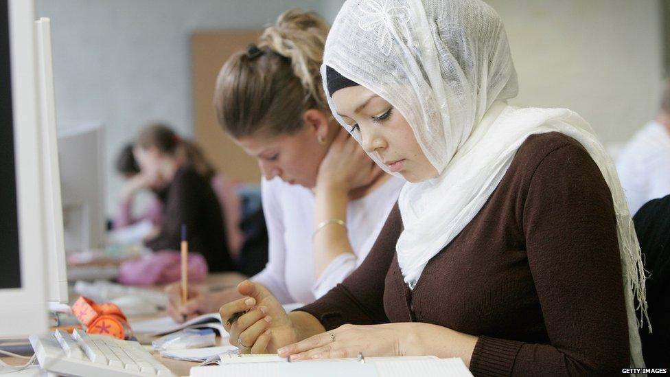 Woman in hijab at desk