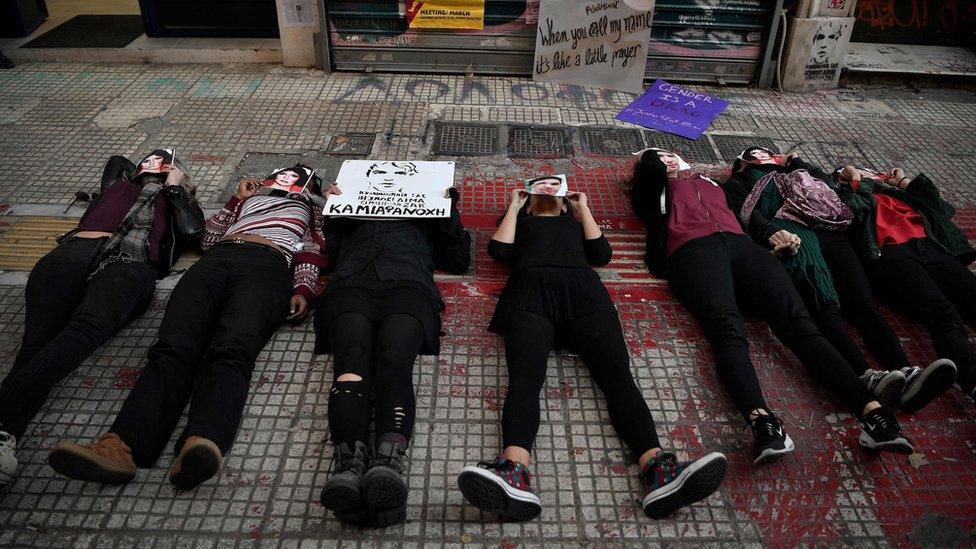 Activists lie down at the spot where activist Zak/Zackie was killed two month ago during a rally n Athens on November 24, 2018, marking the International day for elimination of violence against women