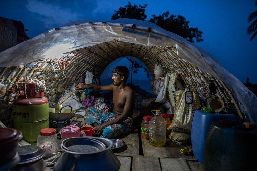 Fisherman Lokman Miah cooking on a fishing boat in Bhola, Bangladesh in 2017