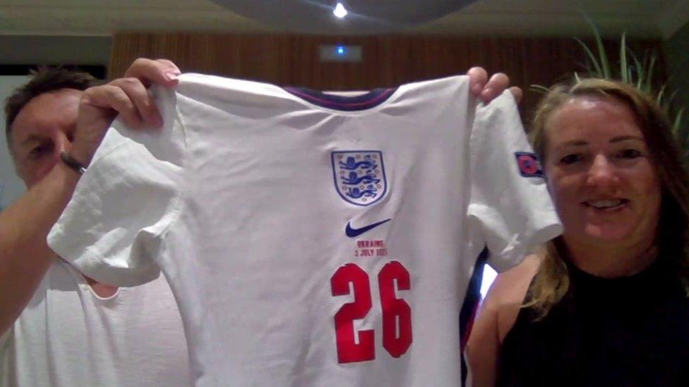 Neil and Tracey Evans holding the shirt