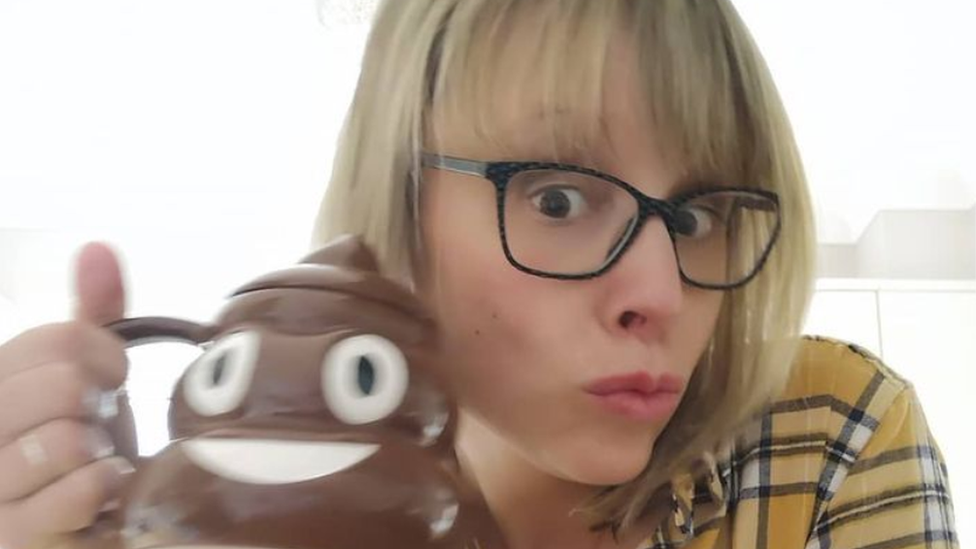 Rachel holding a poo emoji mug